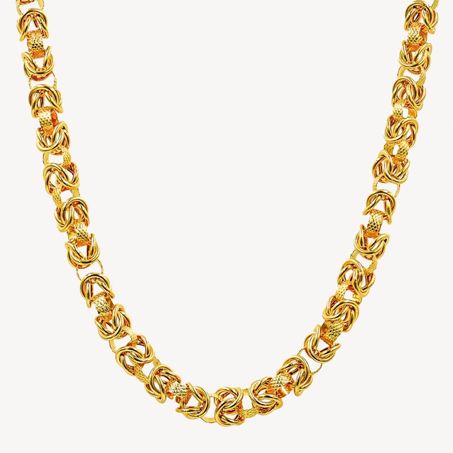 A gold-colored hollow dragonbone chain necklace.