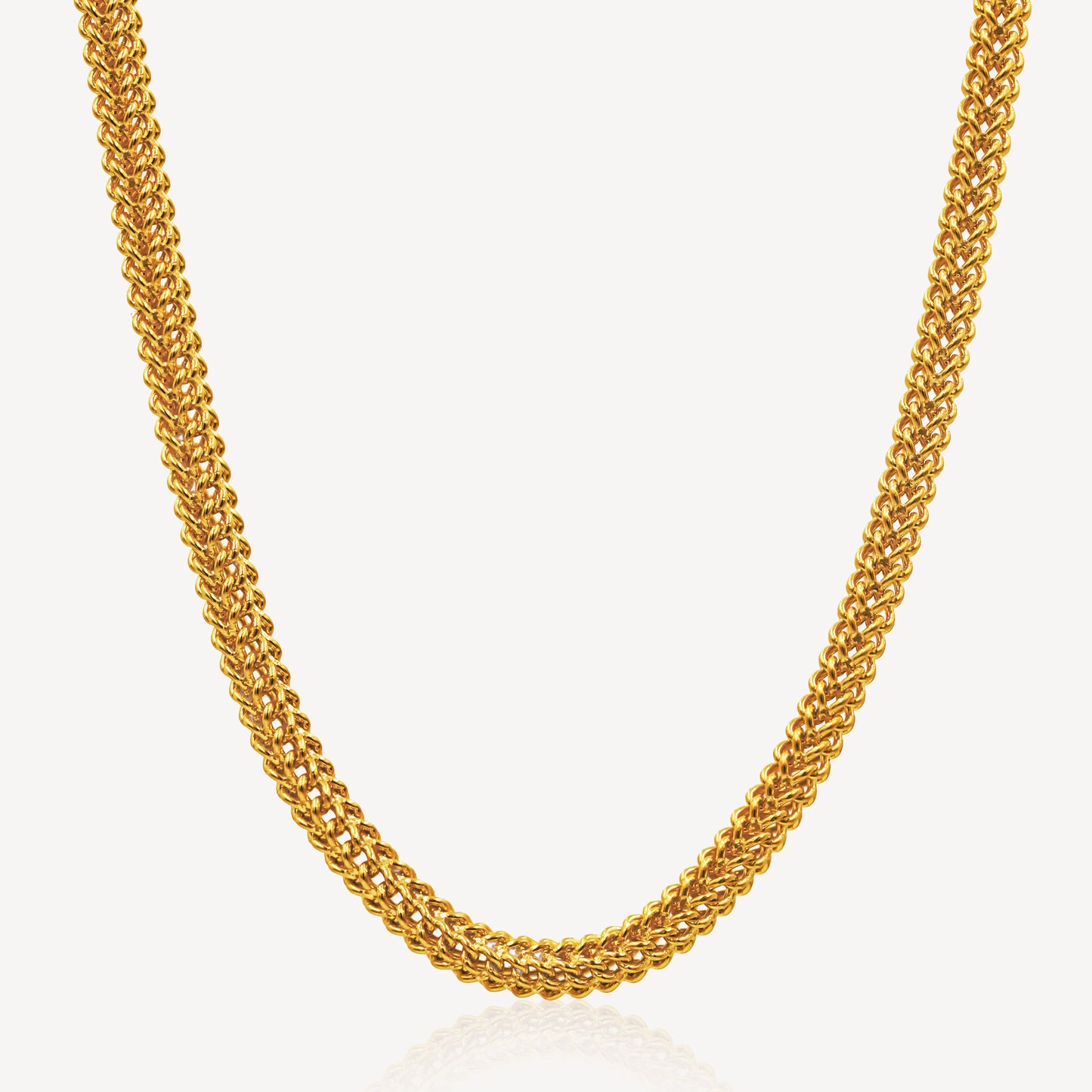 A gold necklace with a hollow dragon chain design, displayed against a white background.